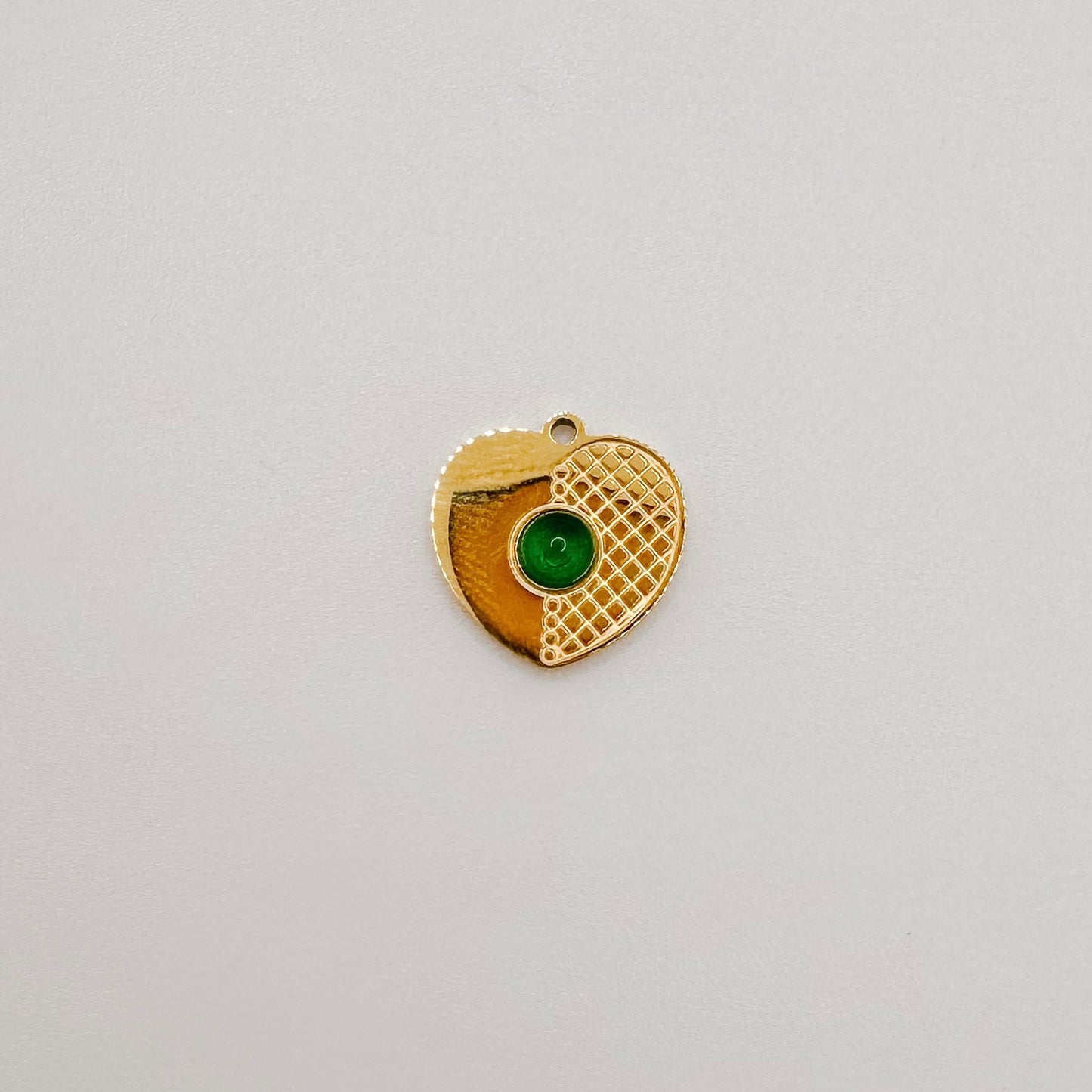 Gold heart with green gem