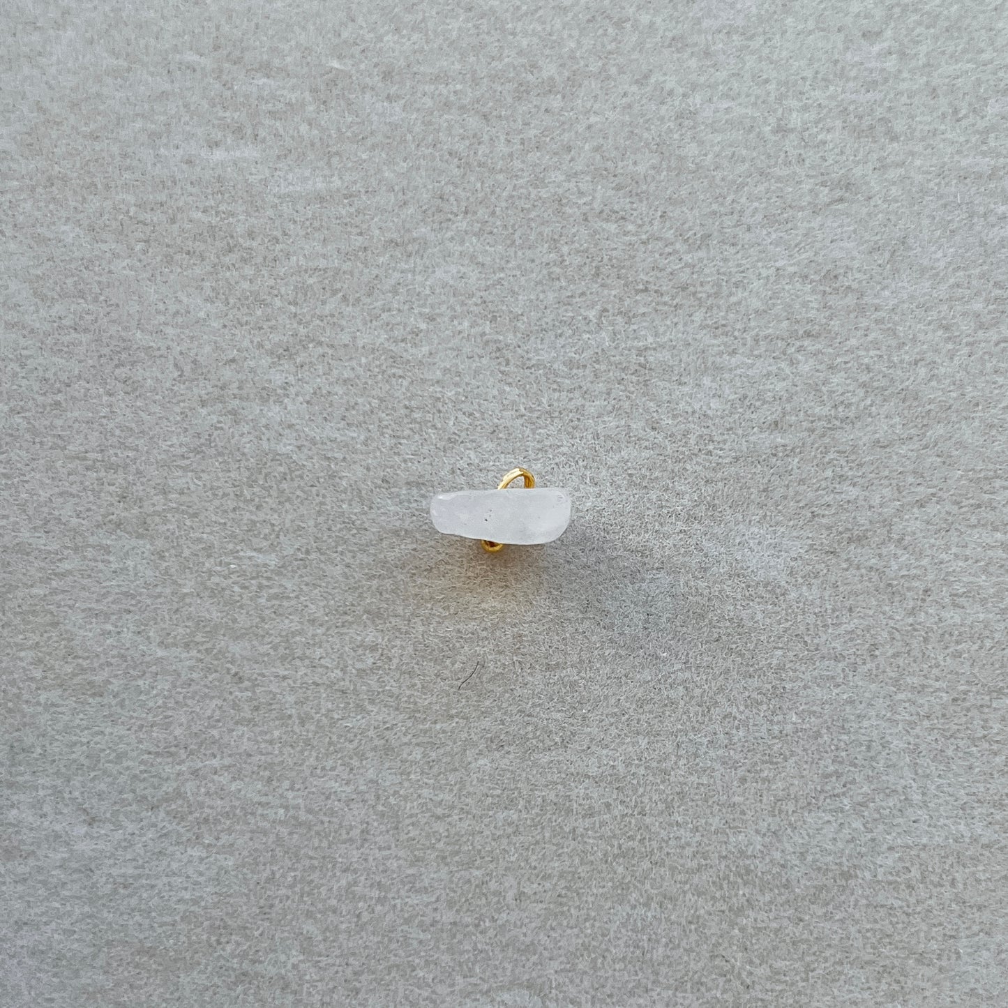 Tiny gold light pink / white gem