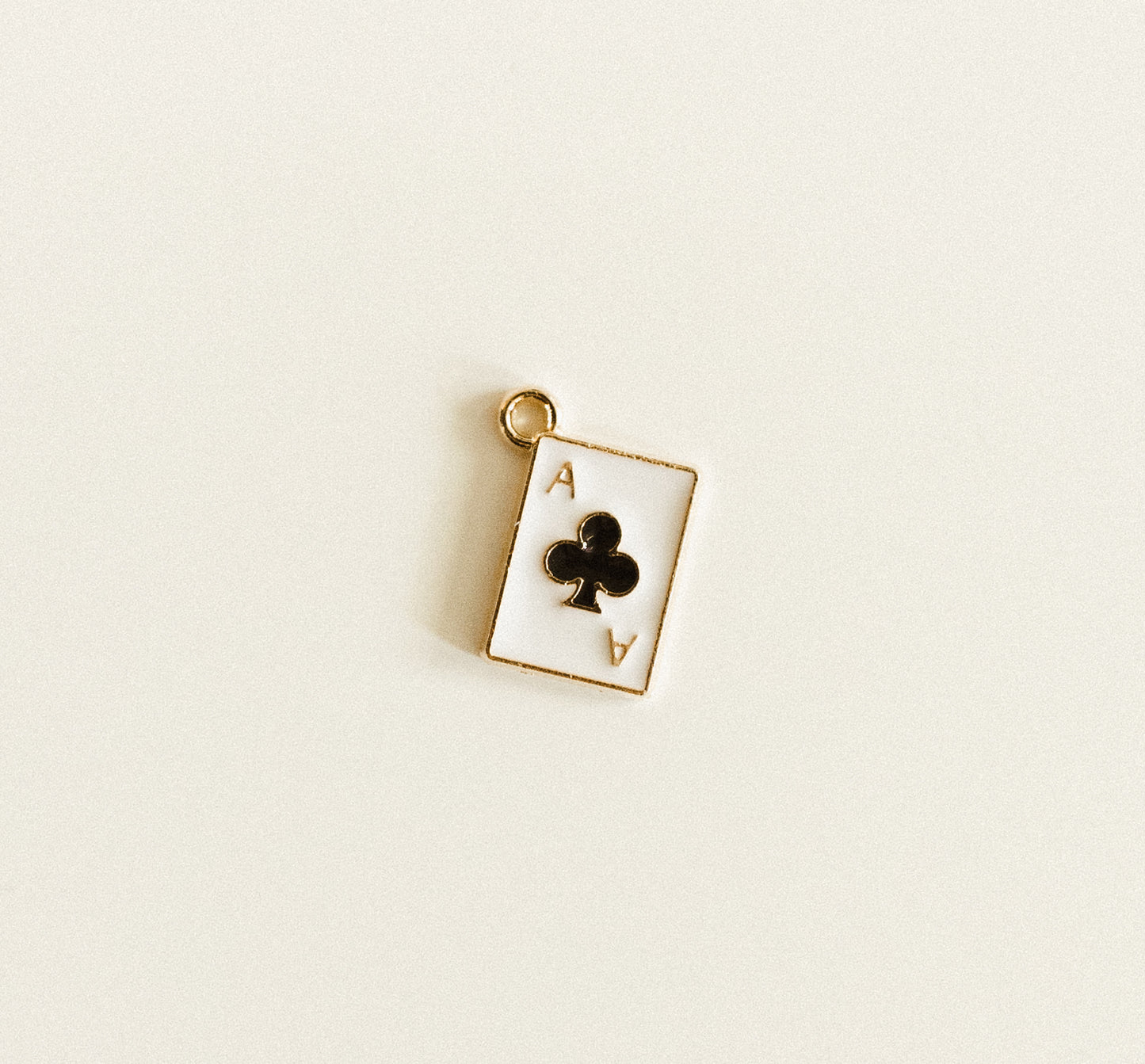 Small gold black ace of clubs card