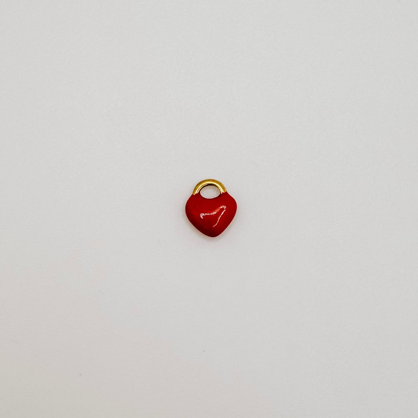 Tiny gold red heart