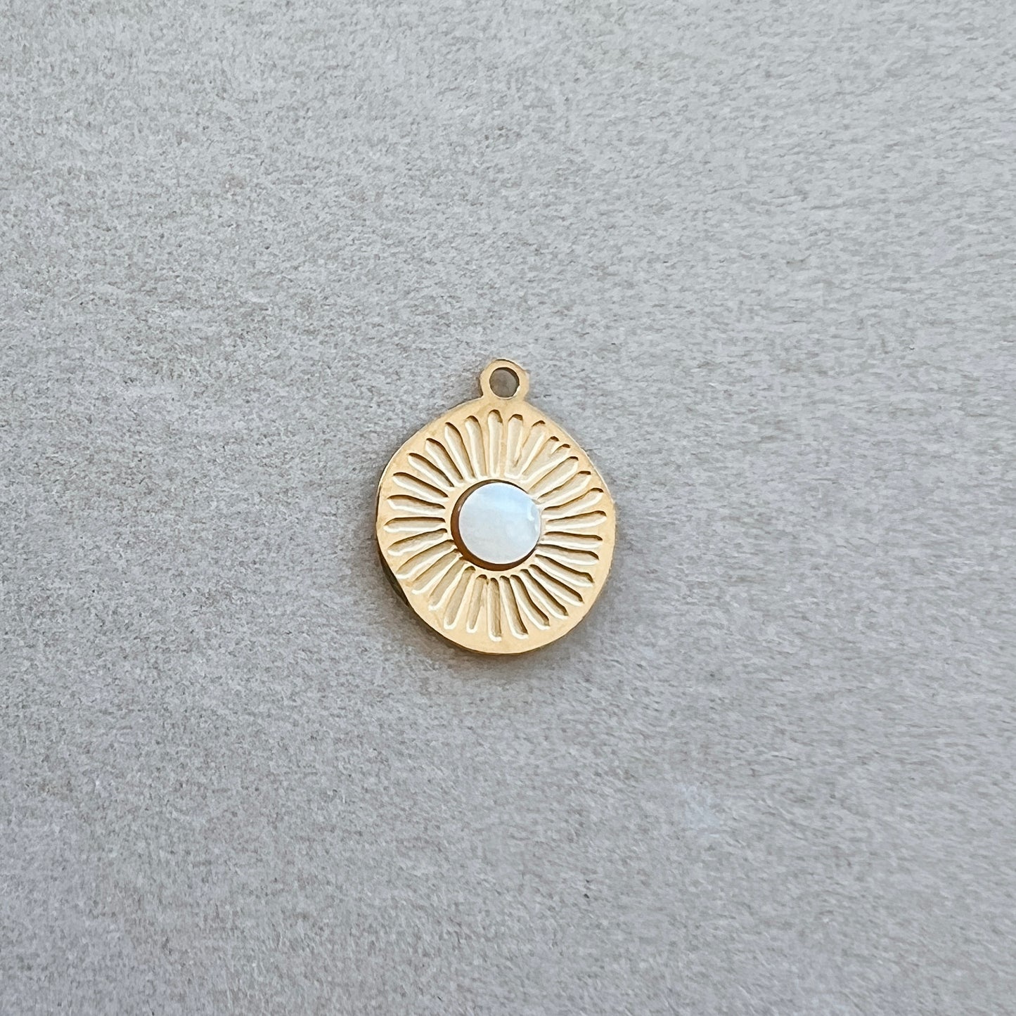 Gold textured circle with white gem