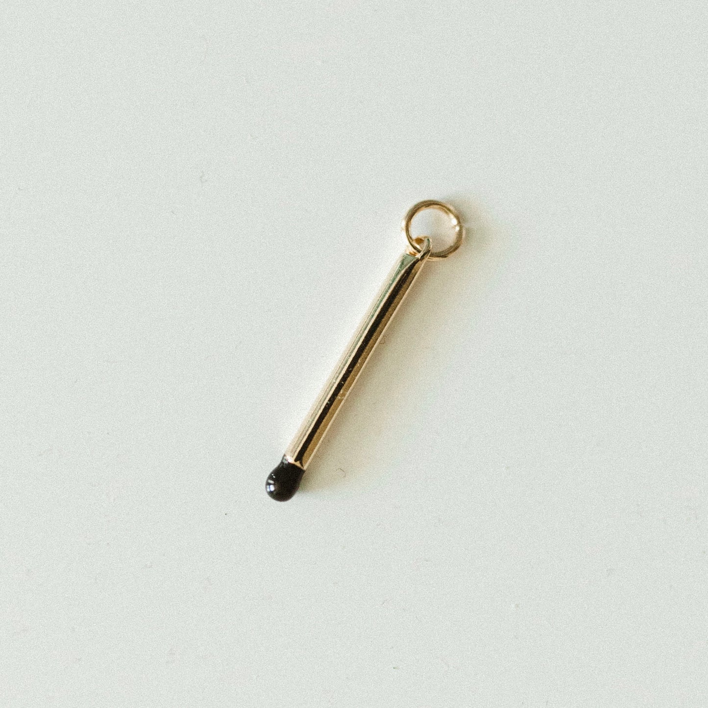 Gold & black match stick