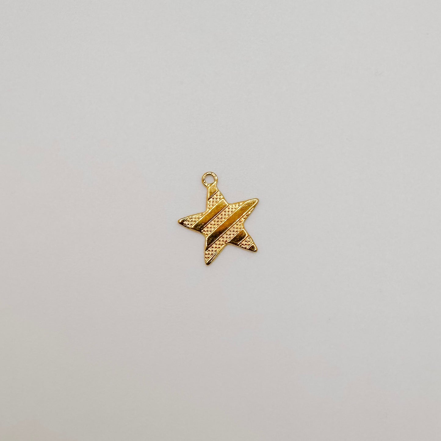 Small flat gold ribbed star