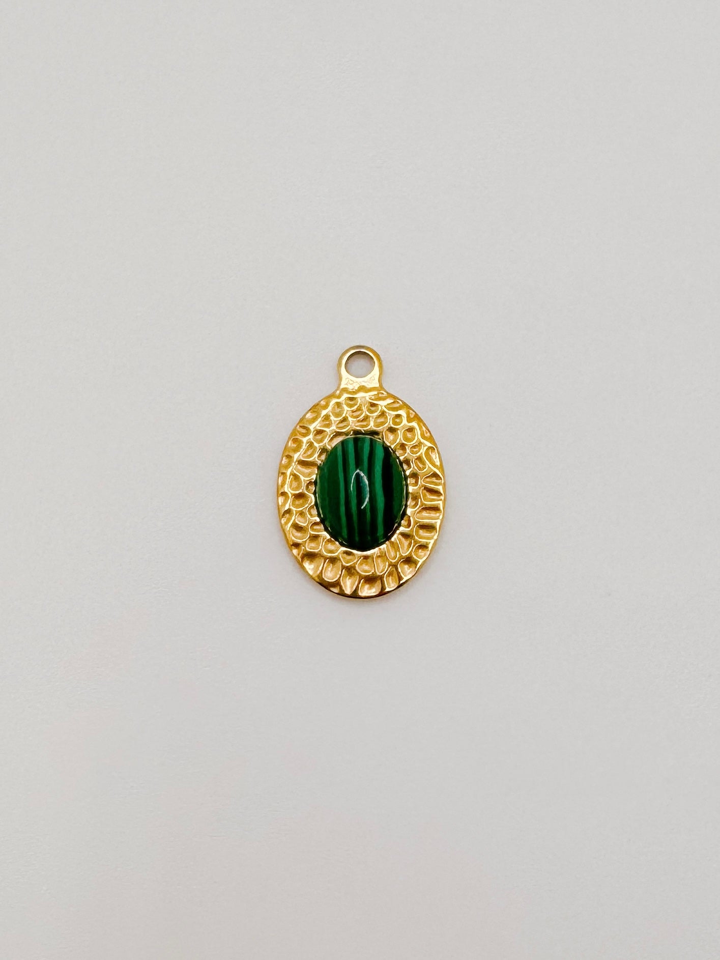 Gold oval green gem