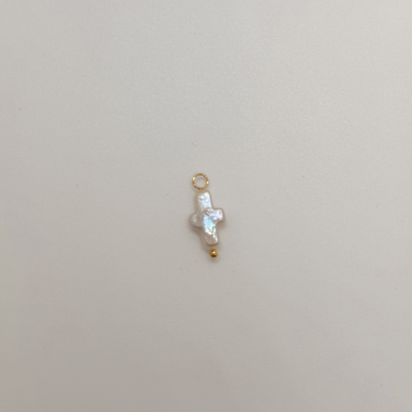 Tiny gold pearl cross