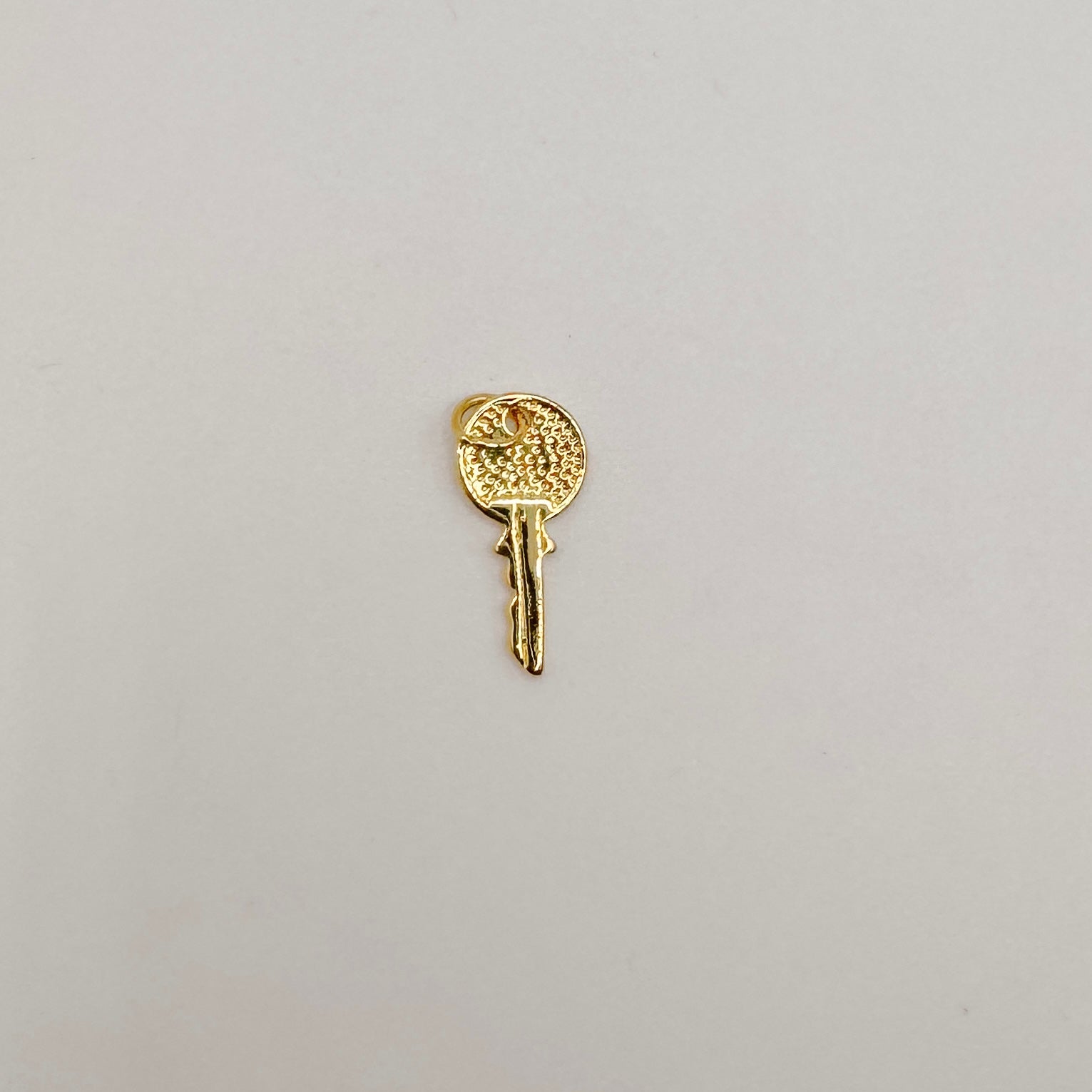 Small gold key – Unjaded Charms