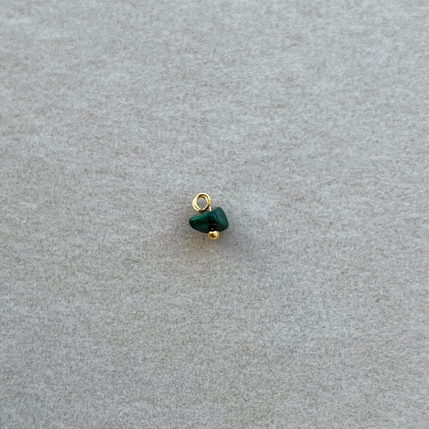 Tiny gold dark green gem